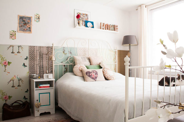 غرفة نوم مكونة من سرير مصنوعة من الحديد باللون الابيض